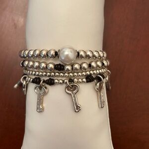 Uno de 50 4 strand bracelet with pearl, keys and charm.